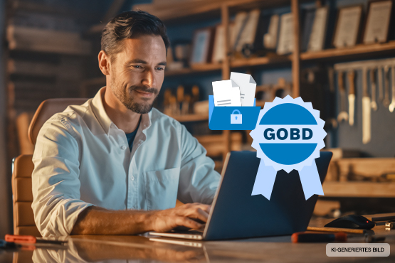 Ein Mann arbeitet an einem Laptop in einer Werkstatt mit Werkzeugen im Hintergrund. GOBD-Logo.